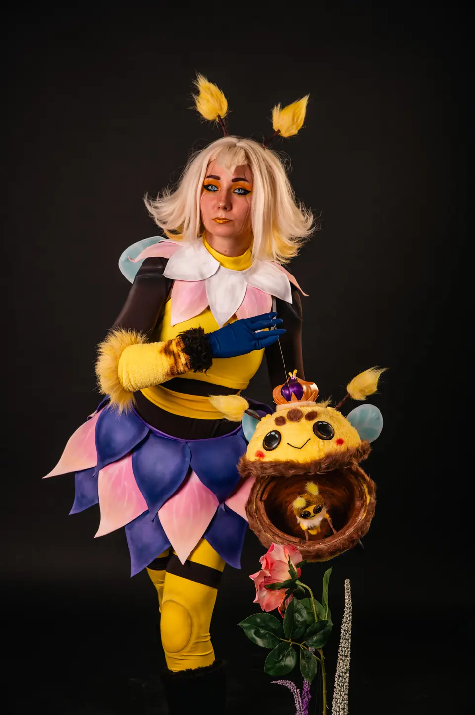 Kally in a bee costume with petal skirt and a plush prop