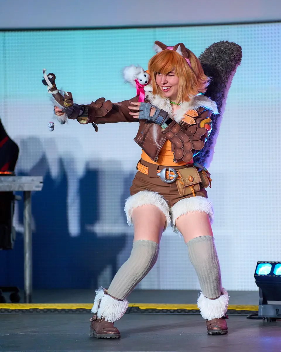 Kally on stage in leather armour with a tail