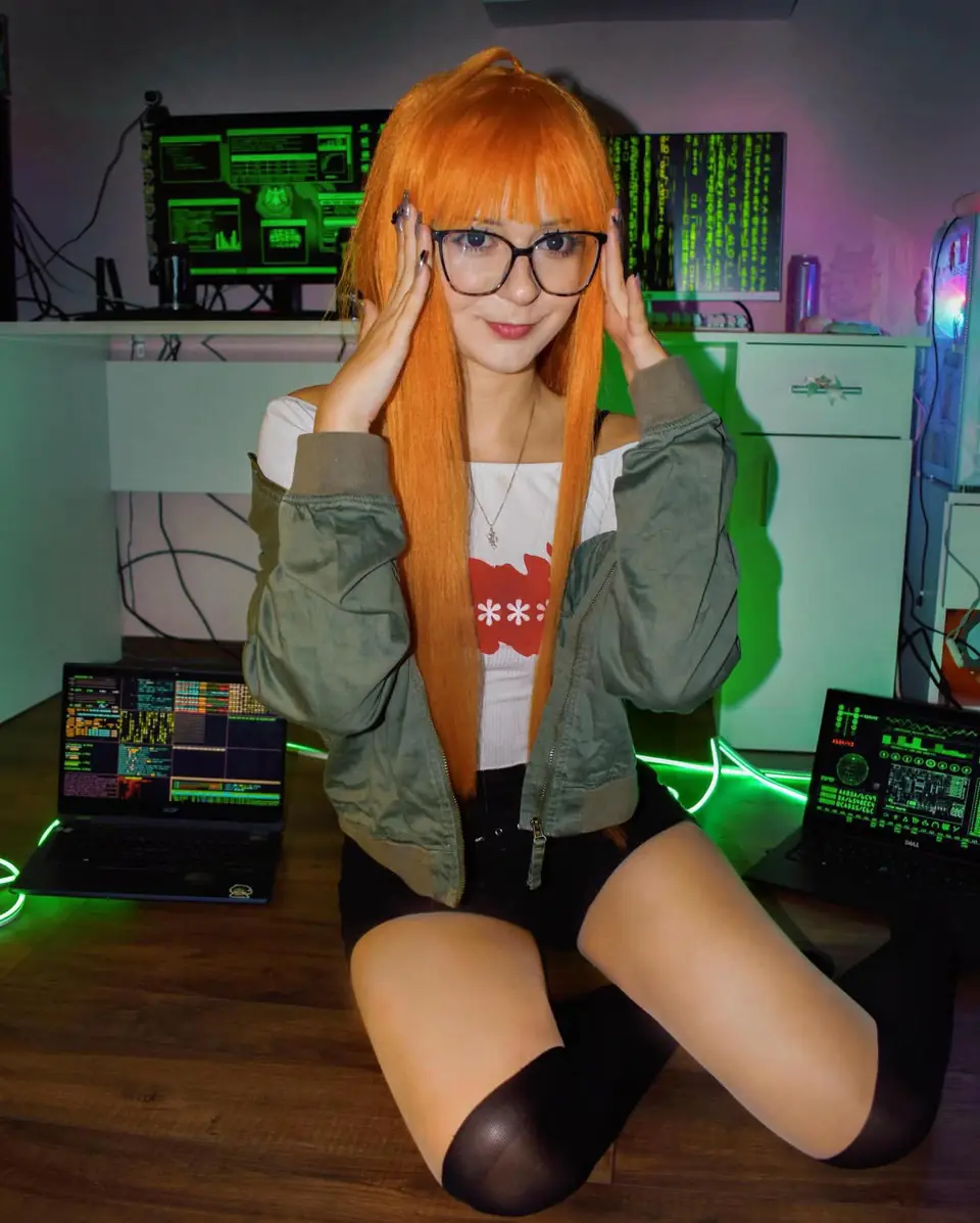 Moni cosplaying in a long orange wig and glasses