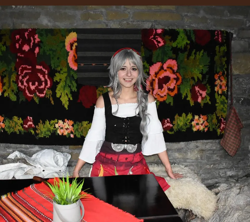 Moni in Bulgarian folk dress with a silver wig